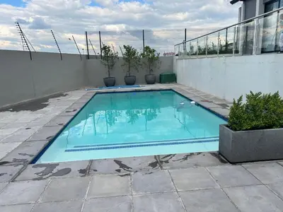 a swimming pool on top of a building at Mellow-Suites Apartments - 31 - WIFI and Netflix in Midrand