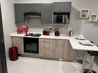a kitchen with a stove and a counter top at Mellow-Suites Apartments - 31 - WIFI and Netflix in Midrand