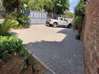 a parking lot with a white truck parked in a driveway at Stay@603 Guesthouse in Pretoria