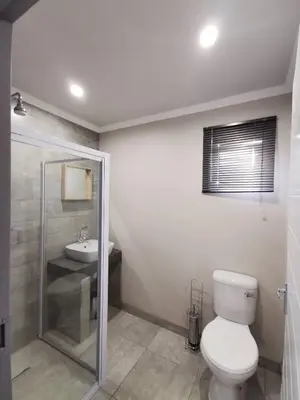 a bathroom with a toilet and a sink at Stay@603 Guesthouse in Pretoria