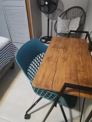 a wooden table with a blue chair in a room at Comfort place 2 in Pretoria