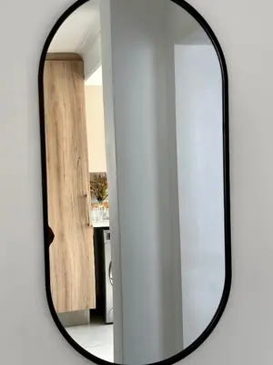 a mirror with a black frame on a white wall at M Luxury Home In Irene Centurion-No Blackouts in Centurion