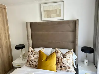 a bedroom with a large bed with yellow pillows at M Luxury Home In Irene Centurion-No Blackouts in Centurion