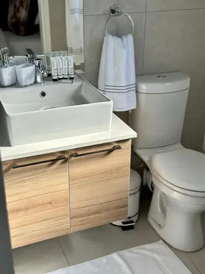 a bathroom with a white sink and a toilet at M Luxury Home In Irene Centurion-No Blackouts in Centurion