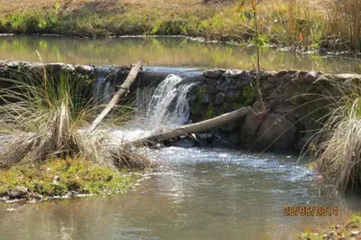 a waterfall in the middle of a body of water at Thandile Country Lodge in Bela-Bela