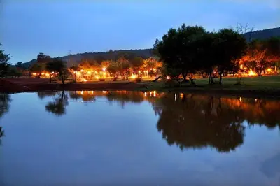 a view of a lake at night with lights at Thandile Country Lodge in Bela-Bela