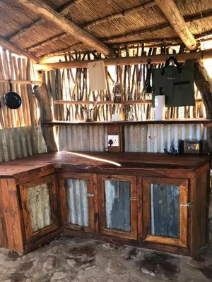 a wooden cabinet with glass doors in a room at Timbaktu River Cottages in Moheme