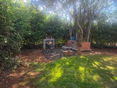 a backyard with a fire pit and a tree at Hartbees Bush Stay #1 in Hartbeespoort