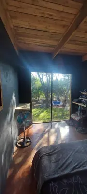 a bedroom with a bed and a large window at Hartbees Bush Stay #1 in Hartbeespoort