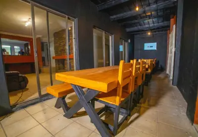 a wooden table and chairs in a room at Adondo-fast accommodation in Pretoria