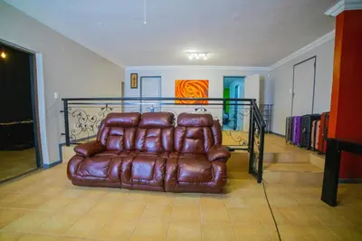a brown leather couch sitting in a living room at Adondo-fast accommodation in Pretoria