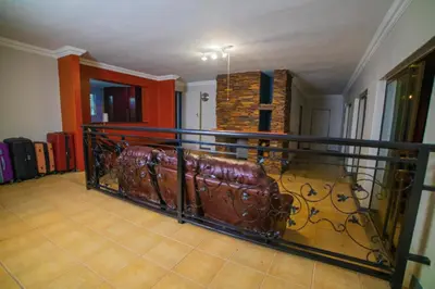 a living room with a couch on a balcony at Adondo-fast accommodation in Pretoria