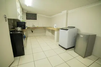 a kitchen with a counter and two refrigerators in it at Adondo-fast accommodation in Pretoria