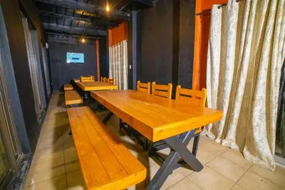 a long wooden table and benches in a room at Adondo-fast accommodation in Pretoria