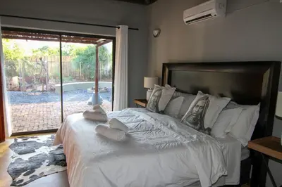 a bedroom with a large bed with towels on it at Ingwe Bush Lodge in Hoedspruit