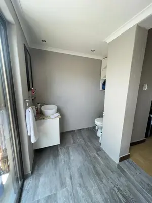 a bathroom with a toilet and a sink at Ingwe Bush Lodge in Hoedspruit