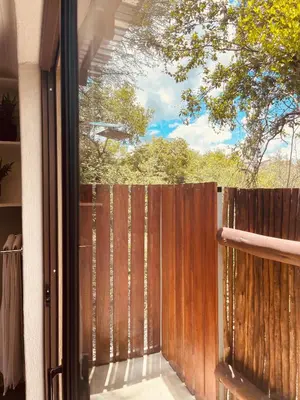 a sliding glass door with a wooden fence at Ingwe Bush Lodge in Hoedspruit