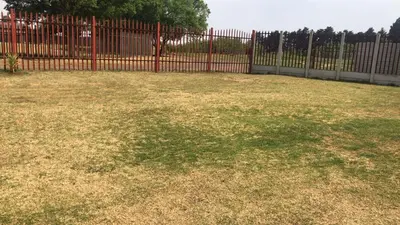 a large yard with a red fence and grass at Home Way Studio Sleeps 2 with Garden in Springs