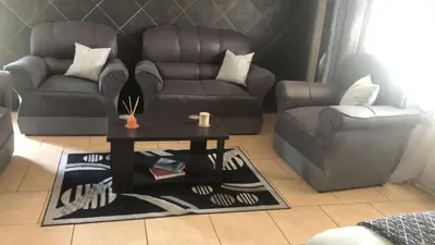 a living room with a couch and a coffee table at Home Way Studio Sleeps 2 with Garden in Springs