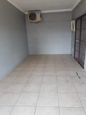 an empty room with a tile floor and a fan at Home Way Studio Sleeps 2 with Garden in Springs