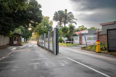 an empty street with a gate on the side of the road at Greencroft Villa in Kempton Park
