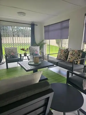 a living room with a couch and a table at Greencroft Villa in Kempton Park