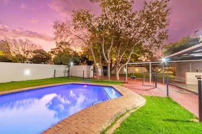 a swimming pool in the yard of a house at Greencroft Villa in Kempton Park