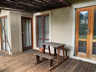 a wooden bench sitting on the porch of a house at Mabalingwe Elephant Lodge 256A in Moheme