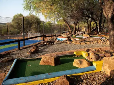 a playground with rocks and a pool of water in a park at Mabalingwe Elephant Lodge 256A in Moheme