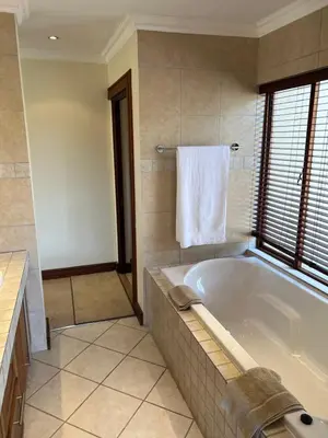 a large bathroom with a tub and a towel at 211 Zebula in Mabula