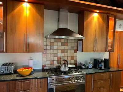 a kitchen with wooden cabinets and a stove top oven at 211 Zebula in Mabula