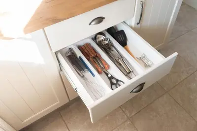 a white cabinet with a drawer filled with utensils at Country Side Cottage @ Low's Creek in Louwʼs Creek