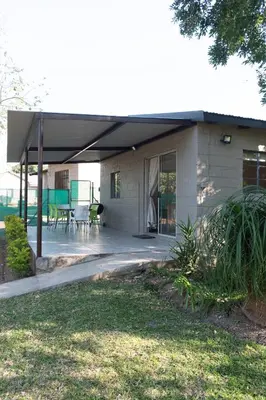a house with awning and a patio at Country Side Cottage @ Low's Creek in Louwʼs Creek