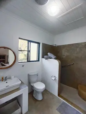 a bathroom with a toilet and a sink and a shower at Giraffe Studio @ Kruger in Marloth Park