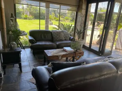 a living room with couches and a coffee table at The Lodge on Ilona in Tierpoort