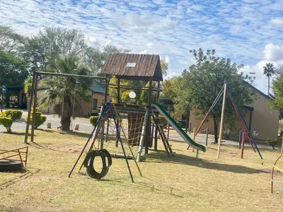 a playground with a slide and a play structure at 86 Pendleberry Holiday Grove in Warmbaths