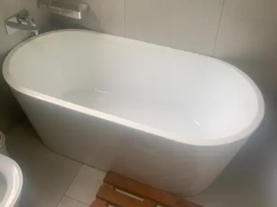 a white bath tub in a bathroom with a toilet at 86 Pendleberry Holiday Grove in Warmbaths