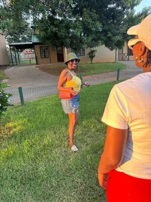 a woman standing in the grass with a frisbee at 86 Pendleberry Holiday Grove in Warmbaths