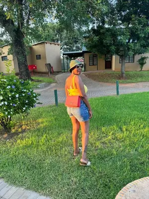 a woman standing in the grass in a field at 86 Pendleberry Holiday Grove in Warmbaths