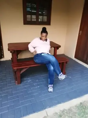 a woman is sitting on a bench at 86 Pendleberry Holiday Grove in Warmbaths