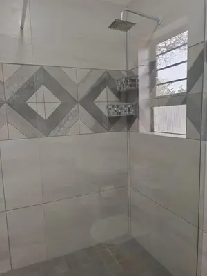 a shower with a glass door in a bathroom at Sonop in Marloth Park in Marloth Park
