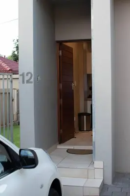 a white car parked in front of a house at Arcardia in Pretoria
