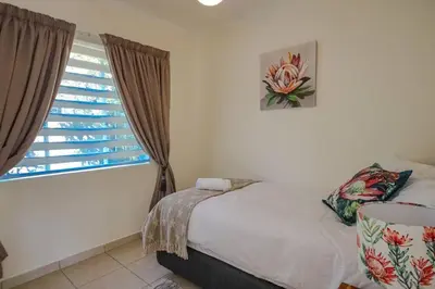a bedroom with a bed and a window at The Lemon Tree Oasis - Solar in Centurion