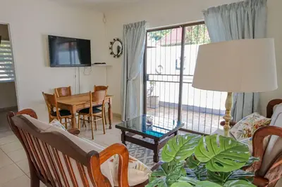 a living room with a couch and a table at The Lemon Tree Oasis - Solar in Centurion