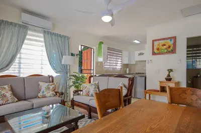a living room with a couch and a table at The Lemon Tree Oasis - Solar in Centurion