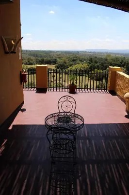 a table on a balcony with a view at Ndlovu Lodge in Pretoria