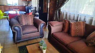 a living room with a couch and a chair at Legaeng Cottage - Serenity in Pretoria