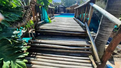 a wooden bridge leading to a swimming pool at Legaeng Cottage - Serenity in Pretoria