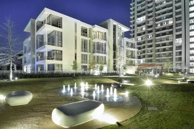 a building with a fountain in front of a building at Luxury 1 bedroom apartment in vibrant Menlyn Maine in Pretoria