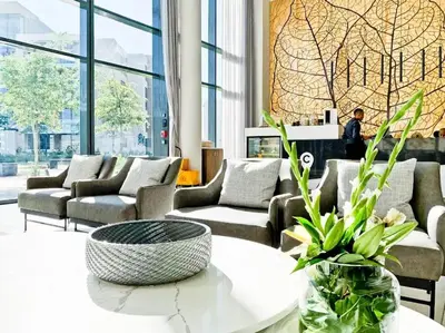 a living room with couches and a table at Luxury 1 bedroom apartment in vibrant Menlyn Maine in Pretoria